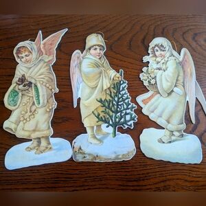 3 hanging cardboard Christmas angels.